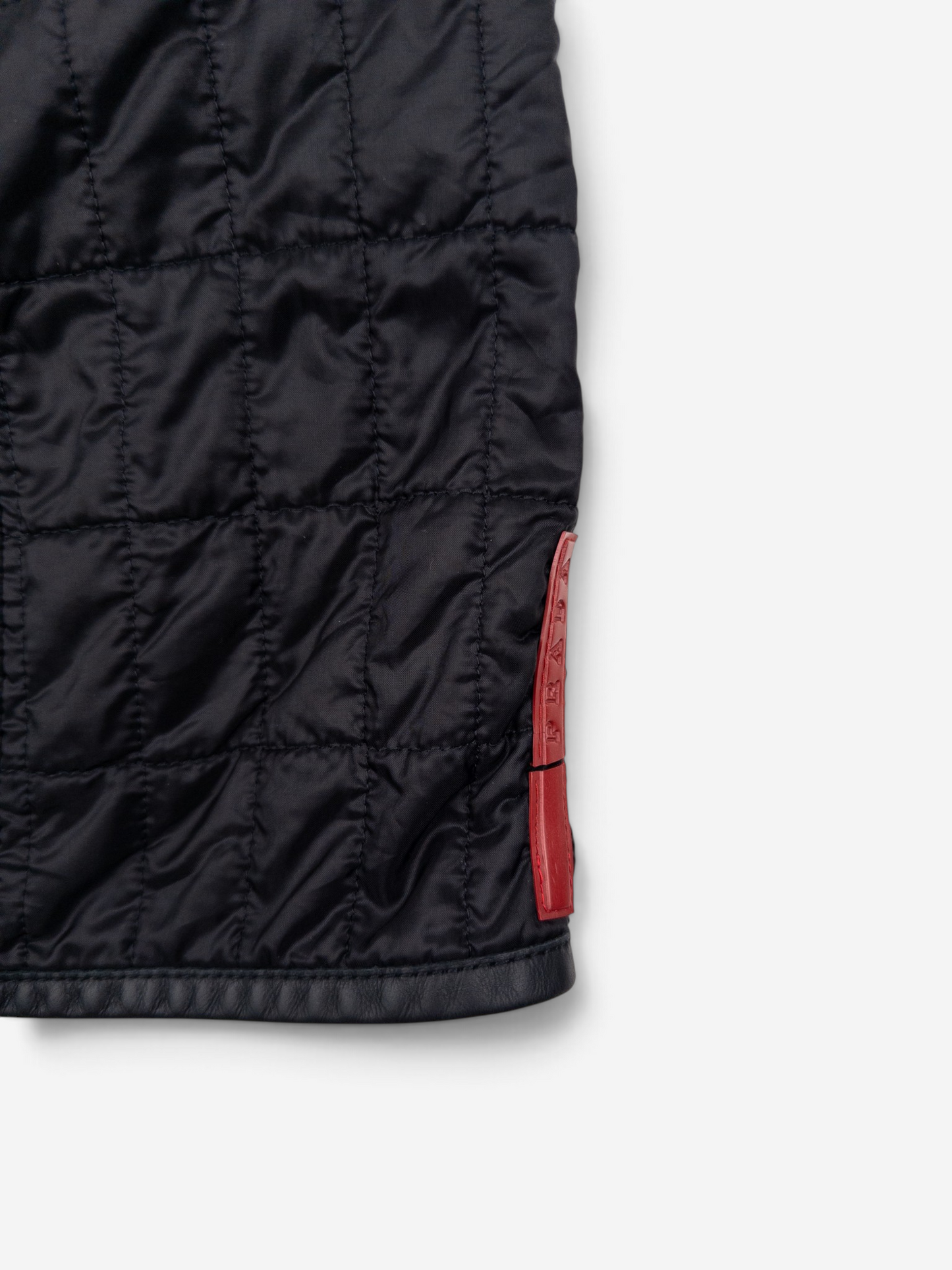 Prada AW99 Linea Rossa Red Tab Padded Quilted Zipper Midi Skirt – side view with logo tab