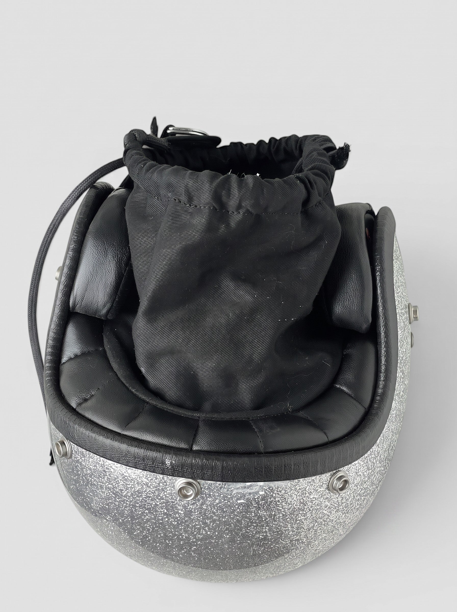 opening act. Maison Margiela Schultertasche in Form eines silbernen Glitzer-Motorradhelms mit schwarzem Stoffbeutel